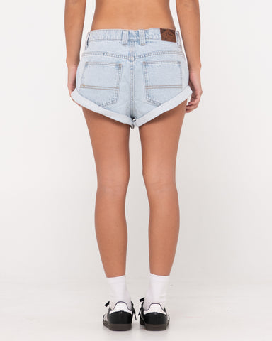 Woman wearing Pheonix Low Rise Denim Mini Short in Sky Blue Heather