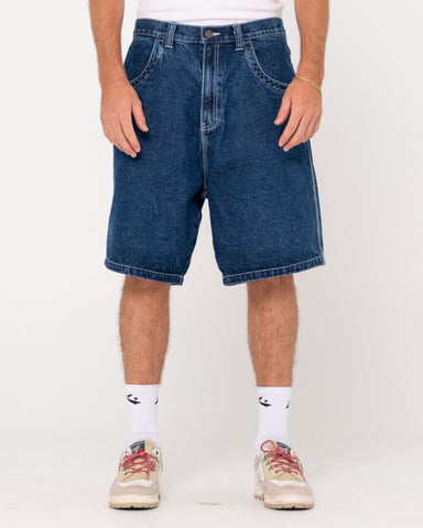 Man wearing Flip Daddy Tapeless Jort - Deep Sea Blue in Deep Sea Blue