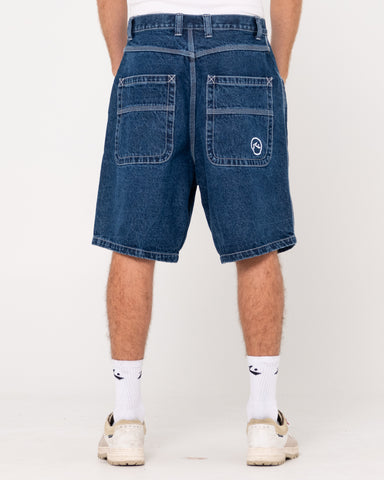 Man wearing Flip Daddy Tapeless Jort - Deep Sea Blue in Deep Sea Blue