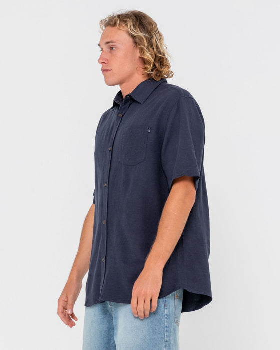 man-wearing-overtone-short-sleeve-linen-shirt-in-navy-blue