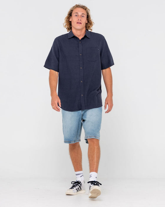 man-wearing-overtone-short-sleeve-linen-shirt-in-navy-blue