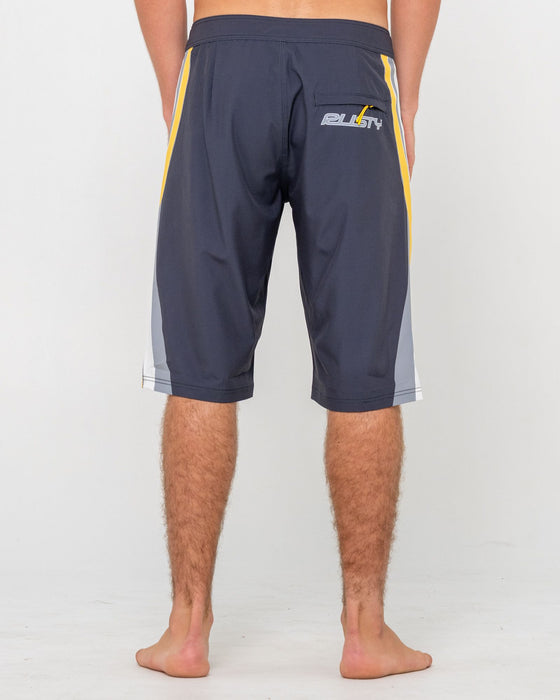 man-wearing-plot-twist-boardshort-in-coal