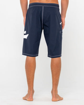 Man wearing Fixed Competition Revolution Boardshort in Navy Blue