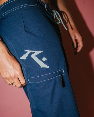 Man wearing Fixed Competition Revolution Boardshort in Navy Blue
