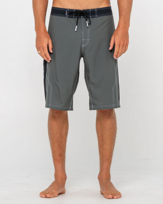 man-wearing-tombstones-fixed-waist-boardshort-in-army-green