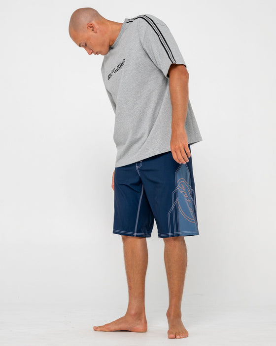 man-wearing-tombstones-fixed-waist-boardshort-in-navy-blue
