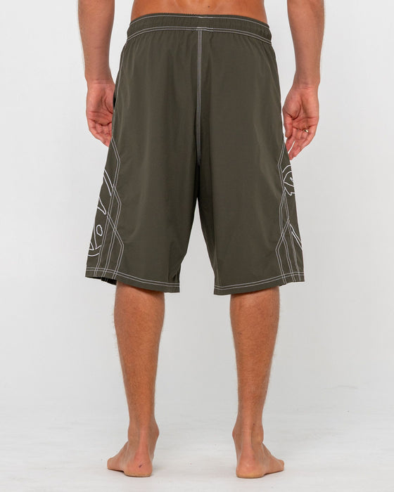 man-wearing-tombstones-hybrid-waist-boardshort-in-army-green