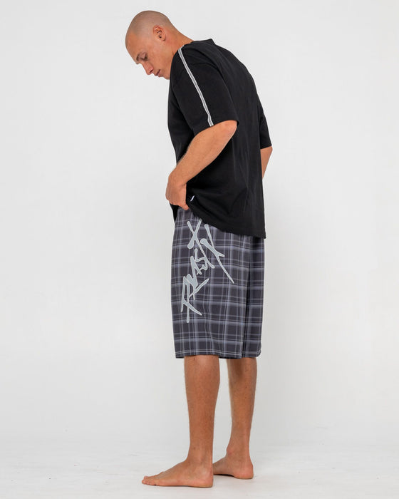 man-wearing-hoodus-fixed-waist-boardshort-in-black