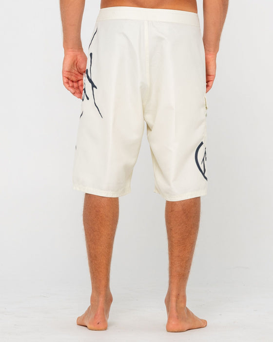 man-wearing-hoodus-fixed-waist-boardshort-in-cream