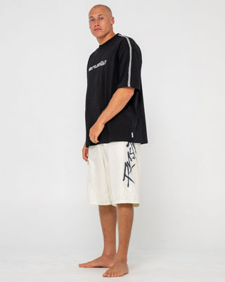 man-wearing-hoodus-fixed-waist-boardshort-in-cream