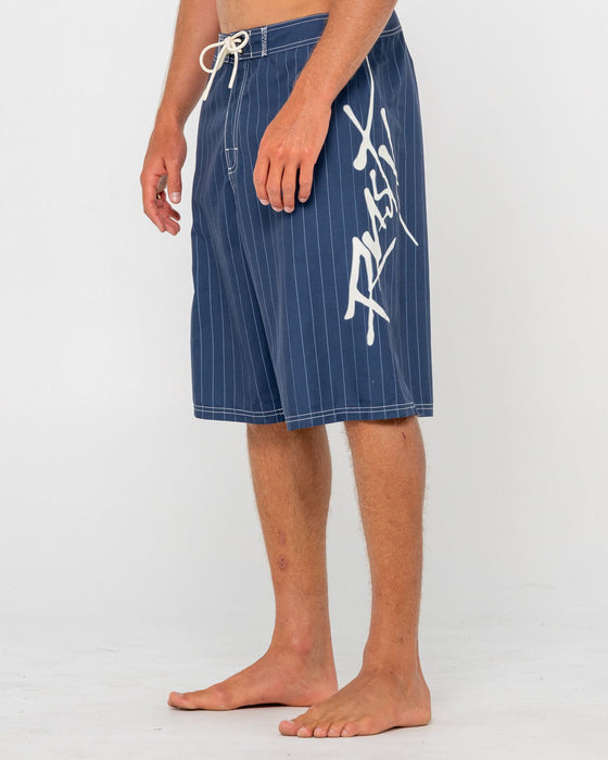 man-wearing-hoodus-fixed-waist-boardshort-in-navy-blue