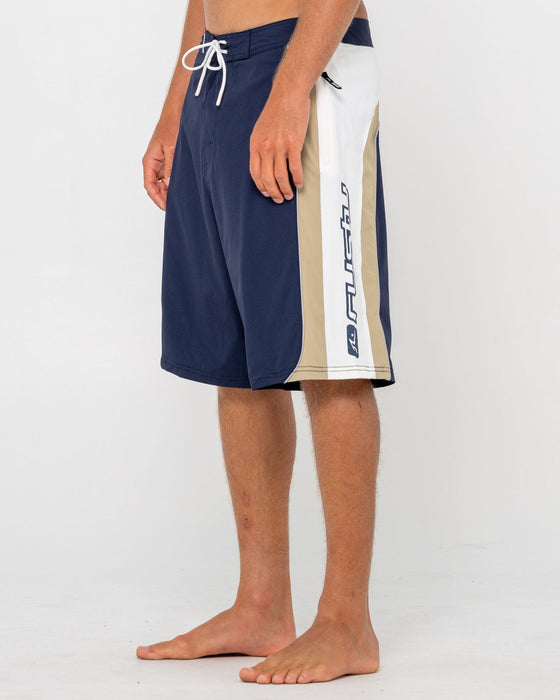 man-wearing-power-wing-fixed-waist-boardshort-in-navy-blue