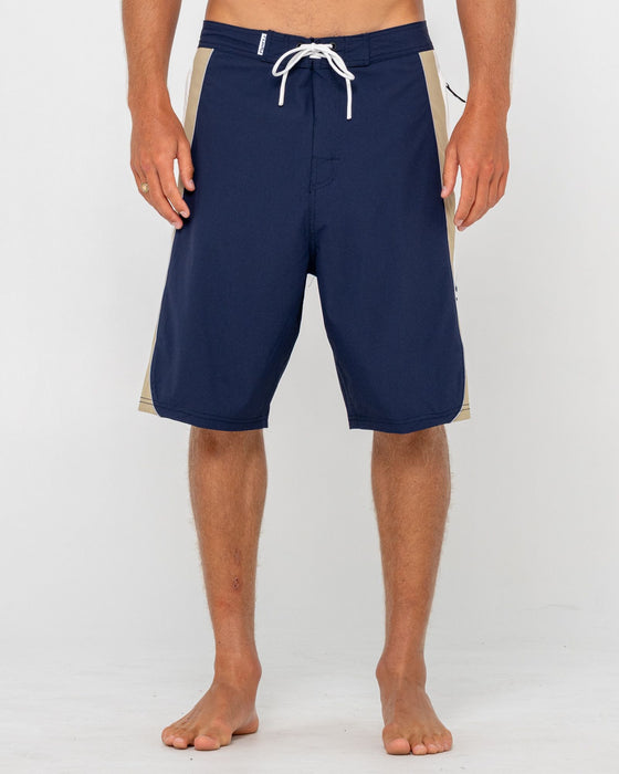 man-wearing-power-wing-fixed-waist-boardshort-in-navy-blue