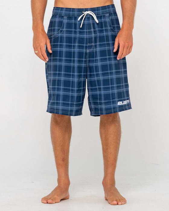 man-wearing-plaid-daddy-elastic-waist-boardshort-in-navy-blue