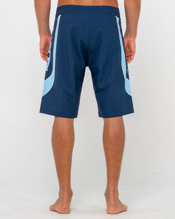 man-wearing-charger-fixed-waist-boardshort-in-navy-blue