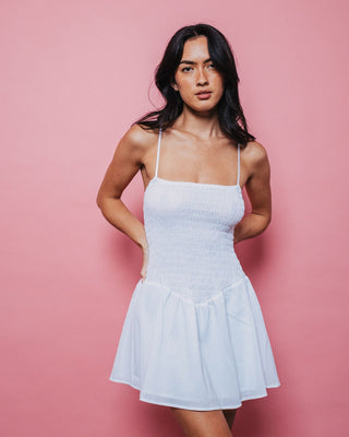 Woman wearing Mimi Smocked Mini Dress in White