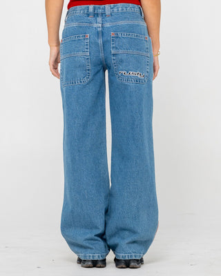 Woman wearing Flip Mommy Low Rise Wide Leg Denim Jean in Middy Blue / Orange