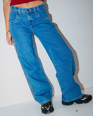Woman wearing Flip Mommy Low Rise Wide Leg Denim Jean in Middy Blue / Orange