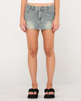 Woman wearing Norty Low Rise Denim Micro Mini Skirt in Dirty Dawg