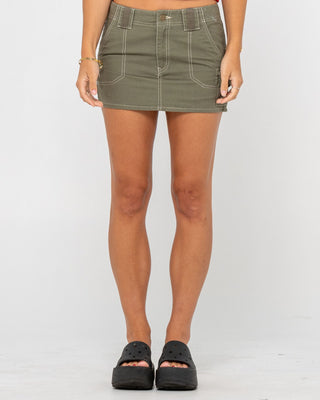 Woman wearing Dirtbag Cargo Low Rise Mini Skirt in Light Khaki