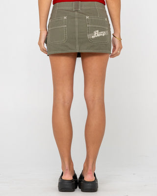 Woman wearing Dirtbag Cargo Low Rise Mini Skirt in Light Khaki
