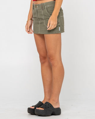 Woman wearing Dirtbag Cargo Low Rise Mini Skirt in Light Khaki