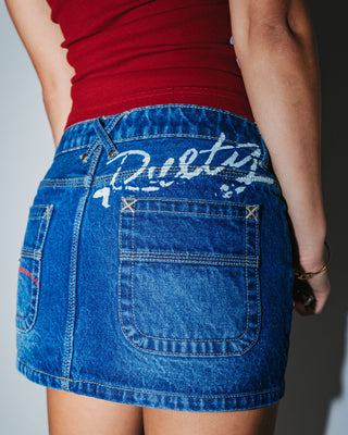 Woman wearing Shorty Low Rise Denim Micro Mini Skirt in Blasted Deep Sea Blue