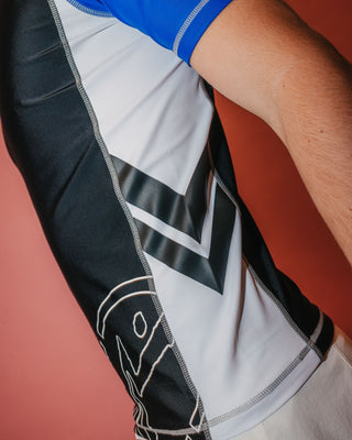 Man wearing Spitfire Short Sleeve Surf Top in Black 1