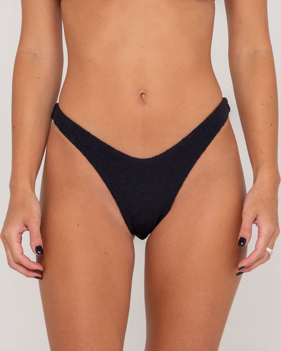 woman-wearing-sandalwood-brazilian-bikini-bottom-in-black