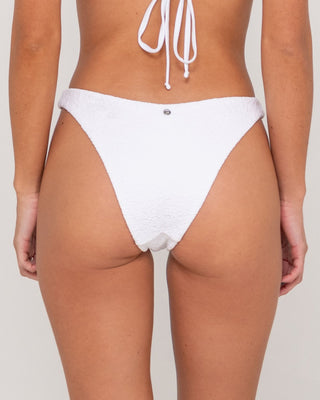 Woman wearing Sandalwood Brazilian Bikini Bottom in Bright White
