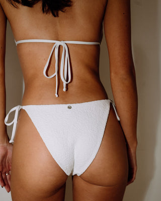 Woman wearing Sandalwood Midi Side Ties Bikini Bottom in Bright White