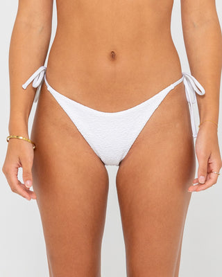 Woman wearing Sandalwood Brazilian Ties Bikini Bottom in Bright White