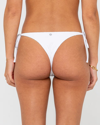 Woman wearing Sandalwood Brazilian Ties Bikini Bottom in Bright White