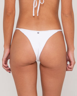 Woman wearing Sandalwood Ring Cheeky Bikini Bottom in Bright White