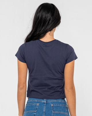 Woman wearing Rusty Essentials Relaxed Mini Tee in Navy Blue