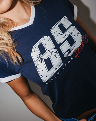 Woman wearing Le Sports Jersey Baby Tee in Navy