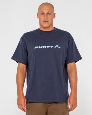 Man wearing Vital Rusty Short Sleeve Tee in Navy Blue 1