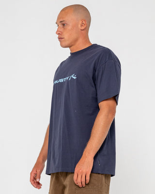 Man wearing Vital Rusty Short Sleeve Tee in Navy Blue 1