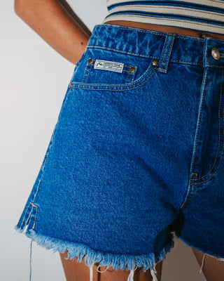 Woman wearing Penny Kick Flare Denim Short in Middy Blue