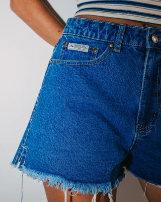 Woman wearing Penny Kick Flare Denim Short in Middy Blue