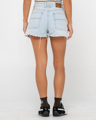 Woman wearing Penny Kick Flare Denim Short in Sky Blue Heather