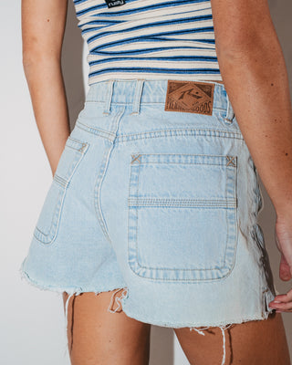 Woman wearing Penny Kick Flare Denim Short in Sky Blue Heather