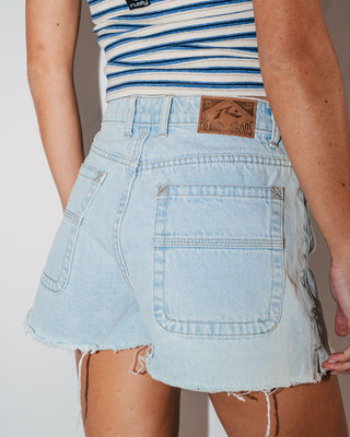 Woman wearing Penny Kick Flare Denim Short in Sky Blue Heather