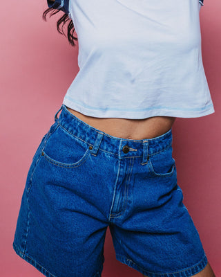 Woman wearing Cyprus High Denim Short in Middy Blue