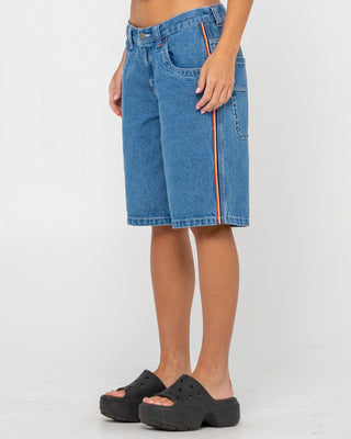 Woman wearing Flip Mommy Low Rise Wide Leg Denim Jort in Middy Blue / Orange