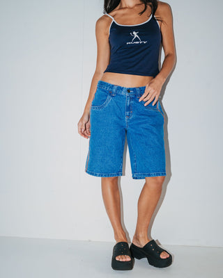 Woman wearing Flip Mommy Low Rise Wide Leg Denim Jort in Middy Blue / Orange