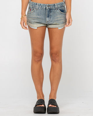 Woman wearing Norty Pheonix Low Rise Denim Mini Short in Dirty Dawg