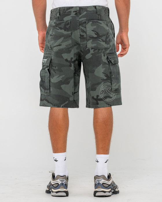 man-wearing-commando-camo-cargo-short-in-overdyed-camo