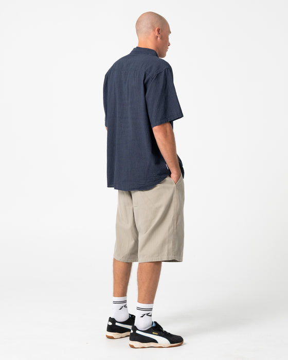 man-wearing-request-line-herringbone-short-in-abbey-stone