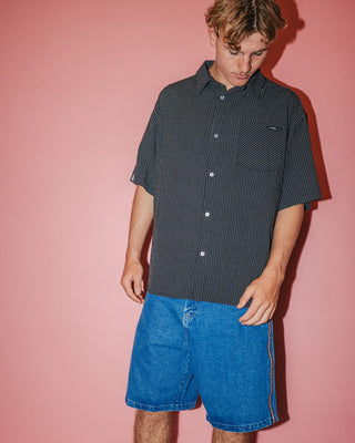 Man wearing Acemo Check Short Sleeve Shirt in Black